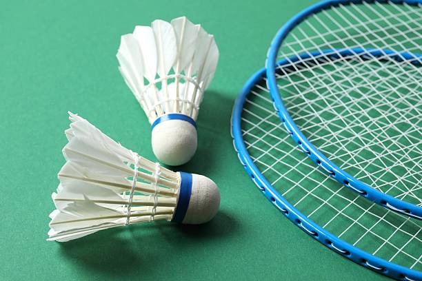 istock Badminton rackets and white badminton shuttlecocks on color background 2252926018