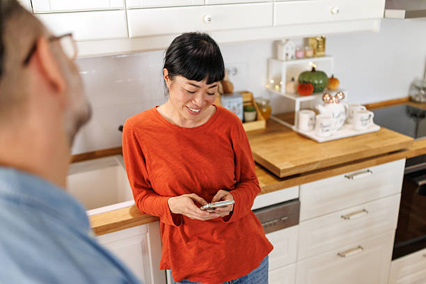 istock Happy couple talking in modern kitchen at home 2252926172