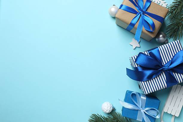 istock Christmas gift boxes and decorations on blue background,  seasonal greeting 2252926309