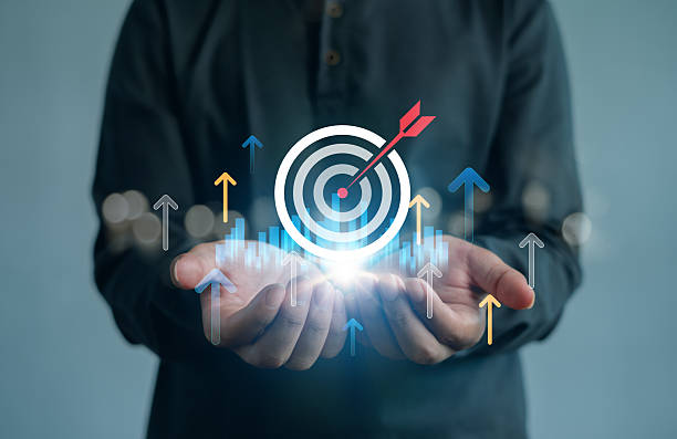 istock Business hands presenting a glowing digital target with upward arrows and bar charts, symbolizing marketing growth, KPI achievement, data analytics, financial success and strategy planning. 2252927209