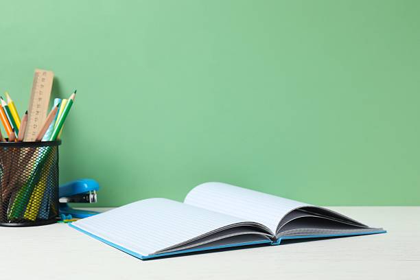 istock Colorful and modern workspace with pencil holder, notebooks and green wall 2252927556
