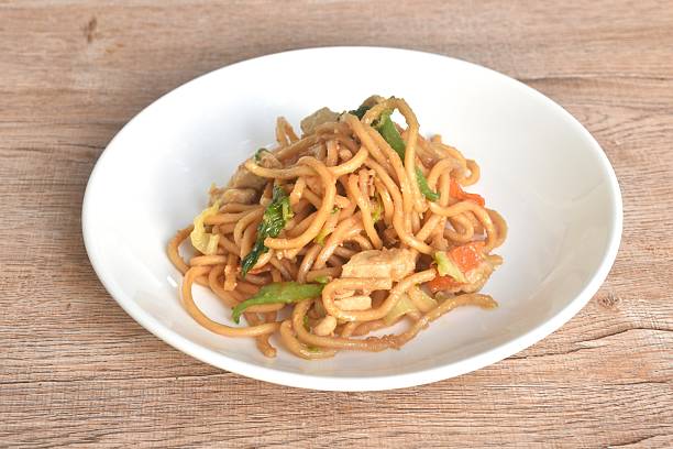 istock fried Chinese noodles slice chicken and celery in soy sauce 2252927820