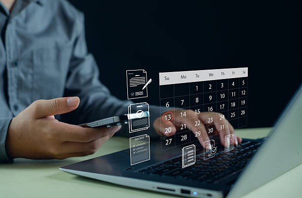 istock Business professional using smartphone and laptop with virtual digital calendar, online document management and task checklist interface, scheduling system and productivity management. 2252928101