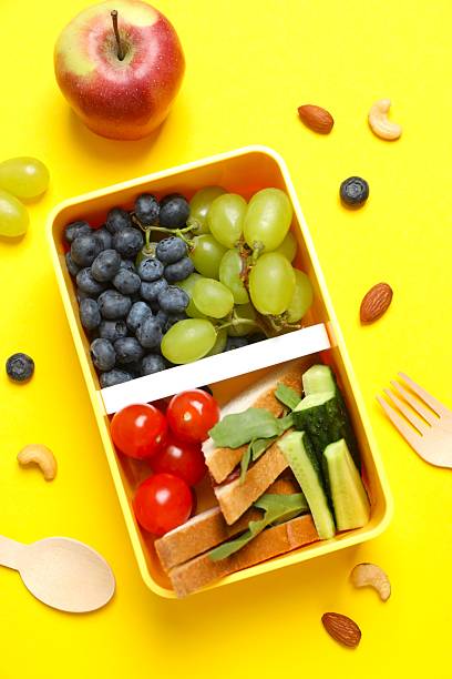 istock Packed lunch with sandwiches, fruits, nuts and vegetables in a divided container 2252928310