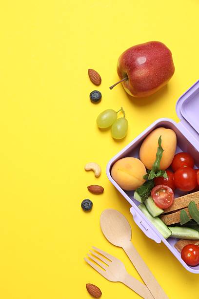 istock Packed lunch with sandwiches, fruits, nuts and vegetables in a divided container 2252928315