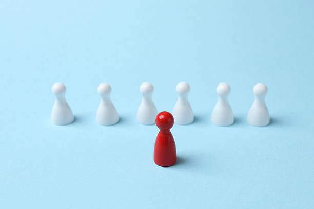 istock Group of pawns on the table. Concept of unity 2252928462