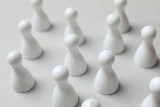 istock Group of pawns on the table. Concept of unity 2252928497