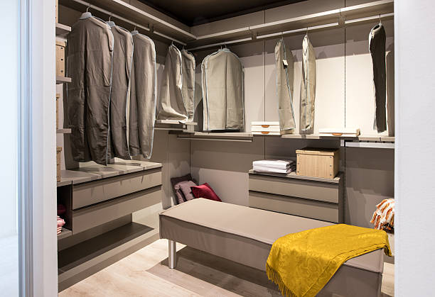 istock Modern walk-in closet interior with organized clothing and bench 2252932637