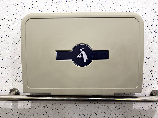 Baby changing symbol on wall mounted foldable table in public restroom. Clear icon for parents, providing visual guidance and enhancing accessibility in modern public infrastructure
