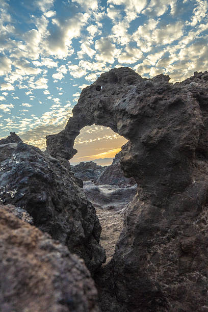 istock Natural Rock Arch At Sunset On Volcanic Coast 2252934951