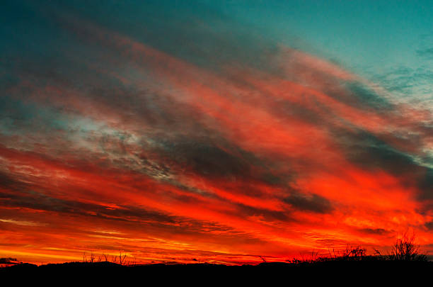 istock Dramatic red sky with stretched gray clouds at early morning 2252935023