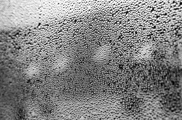 Black and white water droplets on glass expressing quiet sadness background