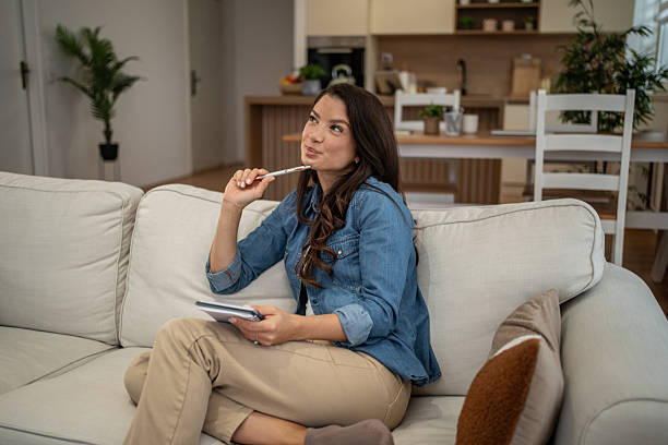istock Young woman creating new ideas holding notepad and pen 2252936336