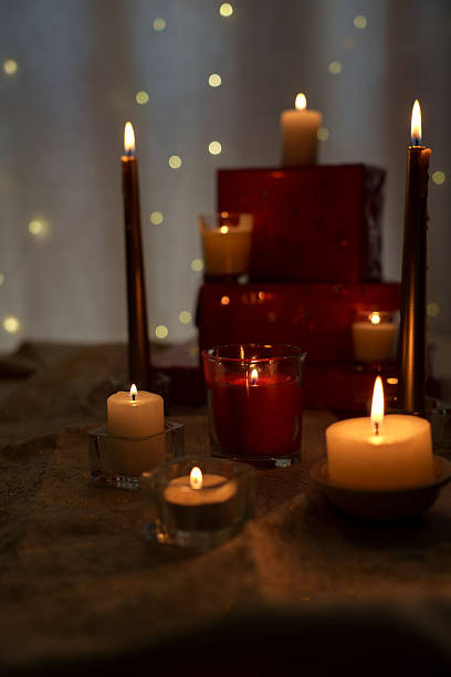istock cozy atmosphere with assorted candles amidst festive decor creating warm glowing ambiance against softly lit background with red accents and flickering lights, seasonal, celebration, wrapped 2252937758