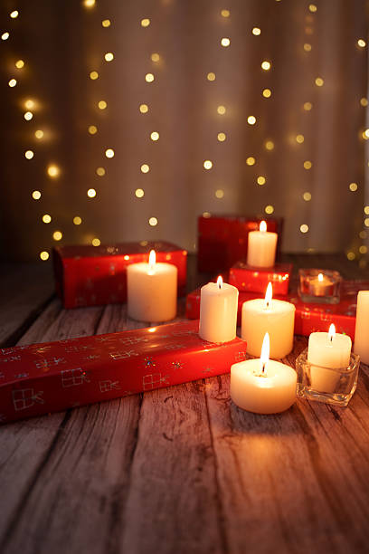 istock warm festive scene with flickering candlelight and red gift boxes on rustic wooden surface against soft bokeh light background, celebration, tranquil, luminous, shining, gleam, decorative, harmony 2252937985