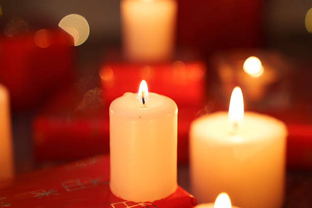 warm ambient candlelight with flickering flames and soft bokeh, creating a cozy and intimate setting amidst red hues and blurred highlights, evening, smooth, texture, gift, present, composition