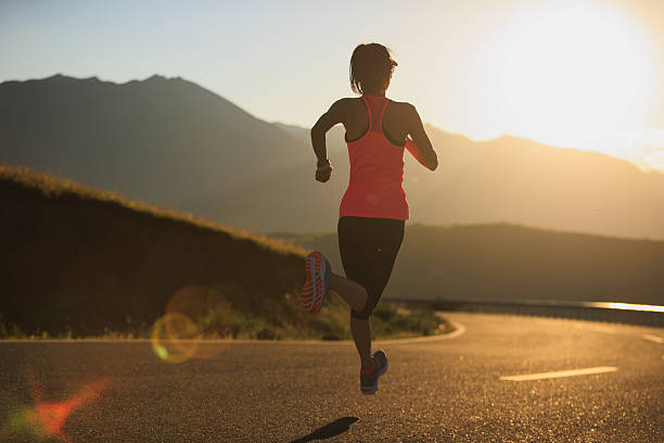 istock Woman runner running in sunset mountain road 2252938150
