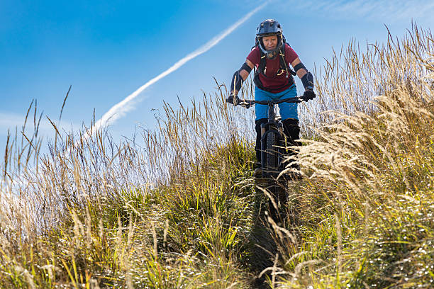 Asian woman riding mountain bike on beautiful mountain top