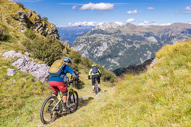 Three experienced and well equipped male mountain bikers are starting their downhill into the next valley in the Friaul mountains of Italy.Canon EOS 5R II, 1/1000, f/5,6 , 24 mm.