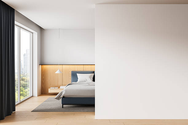 istock Modern bedroom interior with large blank wall perfect for poster mockup or design presentation, featuring clean layout and natural lighting.. 3D Rendering 2252941747