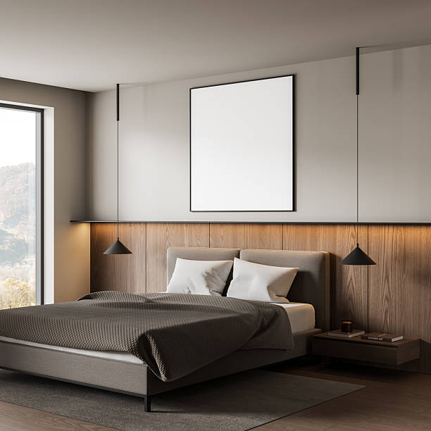 istock Modern bedroom interior with blank poster frame above bed, minimalist design and cozy atmosphere in neutral tones and wooden accent wall. 3D Rendering 2252942014