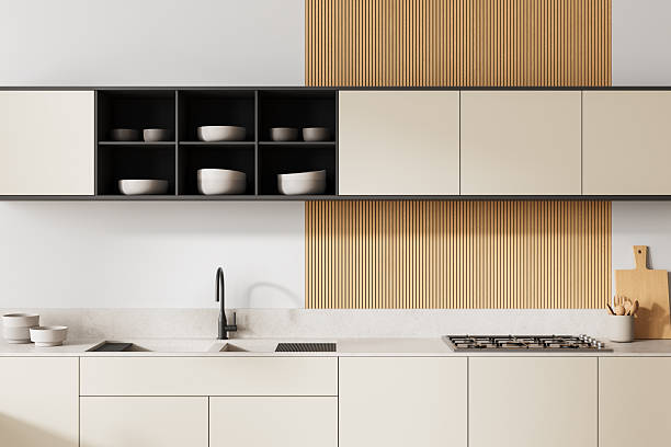istock Minimalist modern kitchen interior with beige cabinets, vertical wood panel accent wall, and clean countertop design in neutral tones. 3D Rendering 2252942320