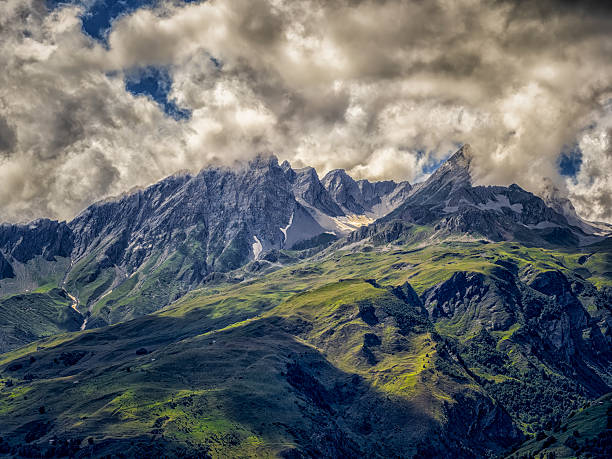 istock Alps mountains with dramatic clouds above green valley 2252942442