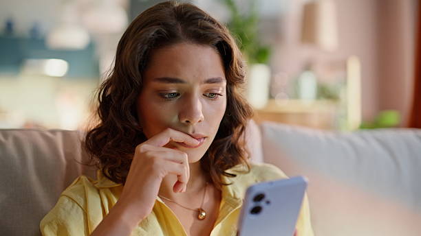 istock Anxious woman browsing smartphone message sitting home couch closeup. Sad lady 2252944488