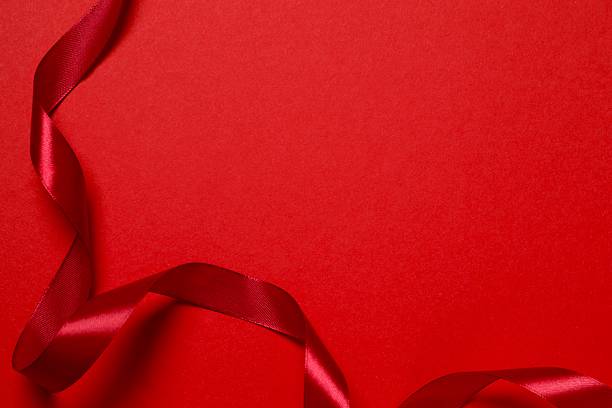 istock Beautiful red silk ribbon on color background 2252945372