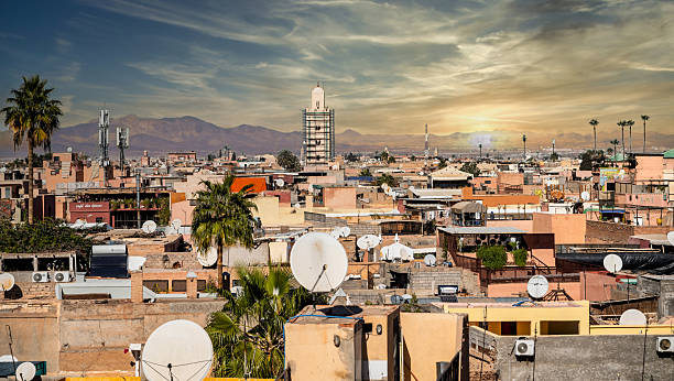 istock Desert City Rooftops With Satellite Dishes At Sunset, Palm Trees And Distant Mountains, Marrakesh, Morocco 2252946580