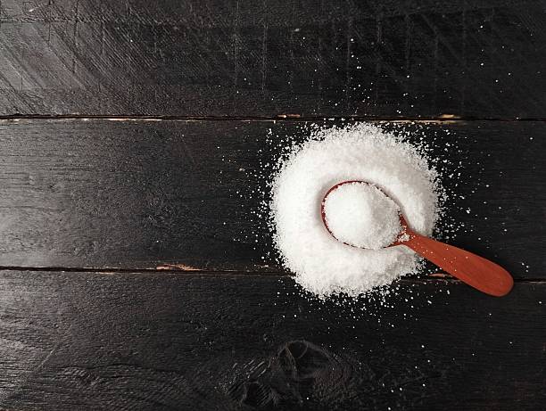 istock Salt on wooden spoon with wooden table background 2252946923