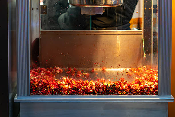 istock Sweet popcorn production inside metal kettle with hot syrup corn kernels and dynamic cooking process 2252946954