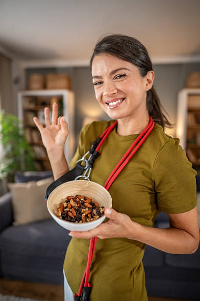 Woman holding trail mix offering healthy snack after workout