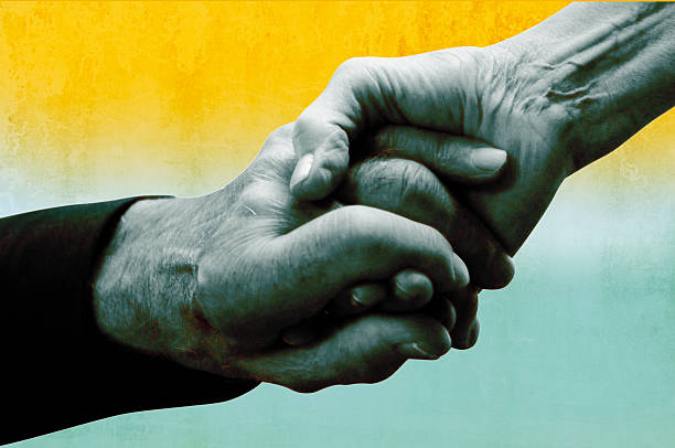 Refugee old peoples hands holding together, close up