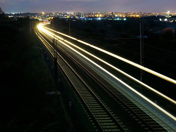 istock A train is traveling down a track at night 2252950486
