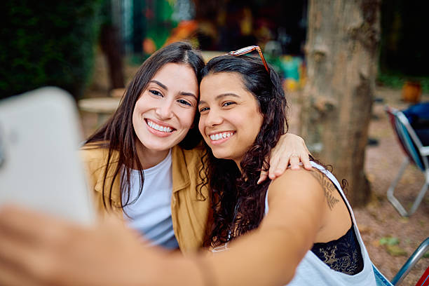 istock Happy young women taking selfie outdoors with smartphone 2252951078