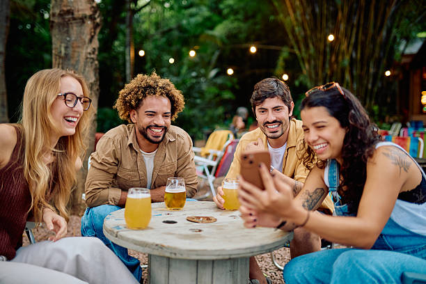 istock Diverse friends laughing watching smartphone outdoors 2252951249