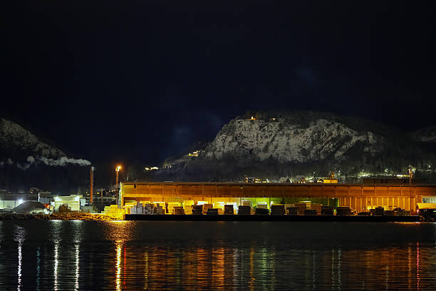 Namsos, Norway - December 13, 2025 : The harbour , industrial area and view point Klumpen in the snowy nightly Norwegian town Namsos in December