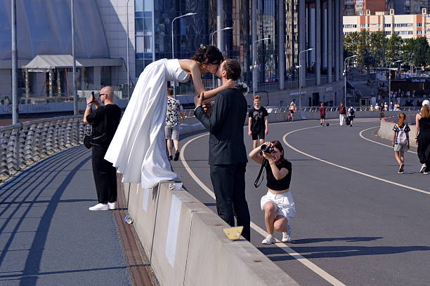 Russia, Saint Petersburg, July 30, 2025. Overpass leading to Gaprom Arena. Weddings One of the customs of newlyweds is to kiss on the bridge and carry the bride in their arms.