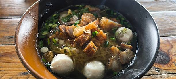 istock Noodle soup in a ceramic bowl on a wooden table 2252957216