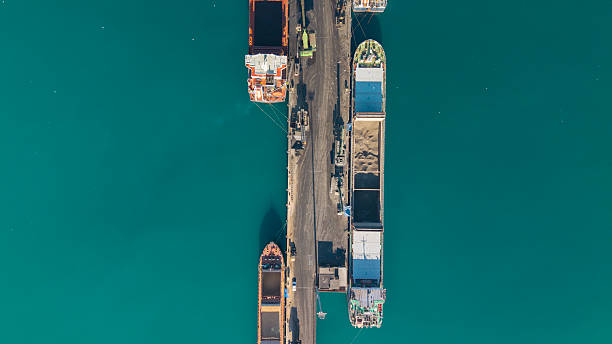 istock Aerial view of cargo ships docked at a port, loading and unloading materials 2252966040