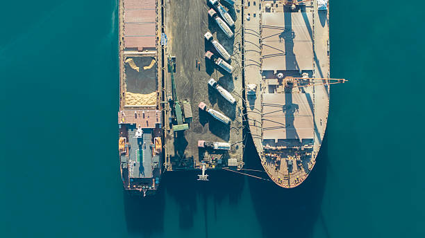 istock Aerial view of cargo ships and trucks at a port loading and unloading bulk materials 2252966454
