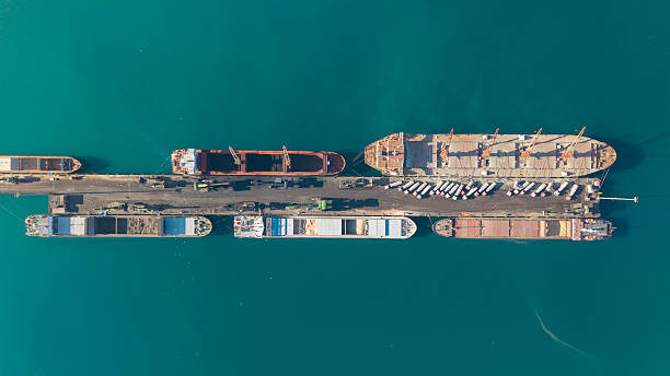 istock Aerial view of cargo ships docked at a port, loading and unloading goods from a pier 2252966456