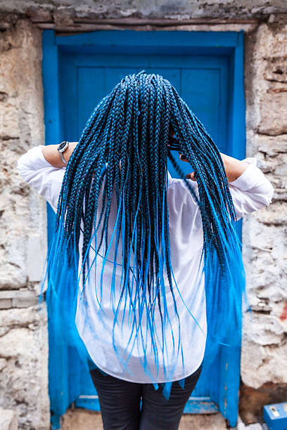 Woman with back turned braided afro long hair