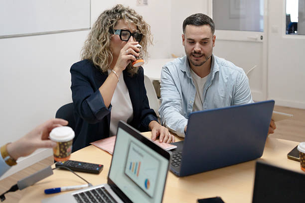 istock Colleagues collaborating on laptop during office meeting 2252973116