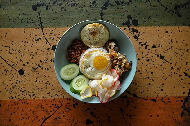 White rice with half-cooked fried egg and sambal matah