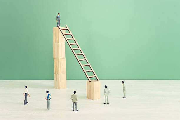 istock business concept of challenge. man figures stand in front ladder. Teamwork and problem solving idea 2252976314