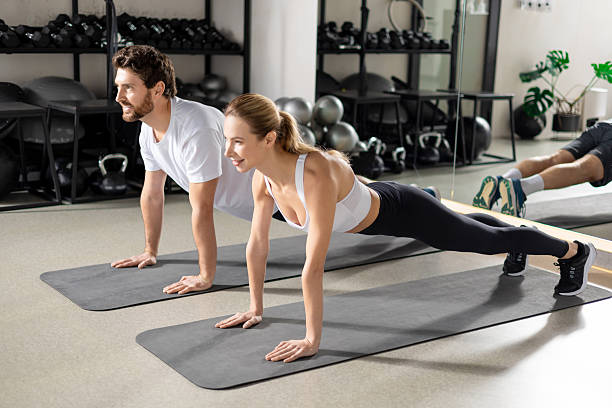 istock Two people having a workout in gym and standing in plank 2252976772