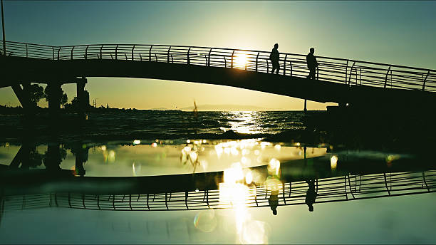 istock People Walking On Bridge At Golden Hour 2252979080