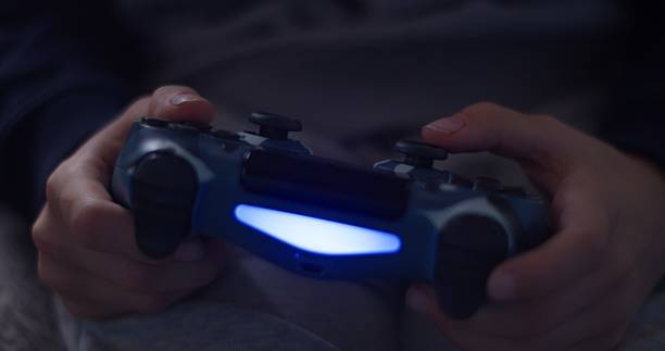 istock Child Holding Video Game Controller – Close-Up Detail 2252980694